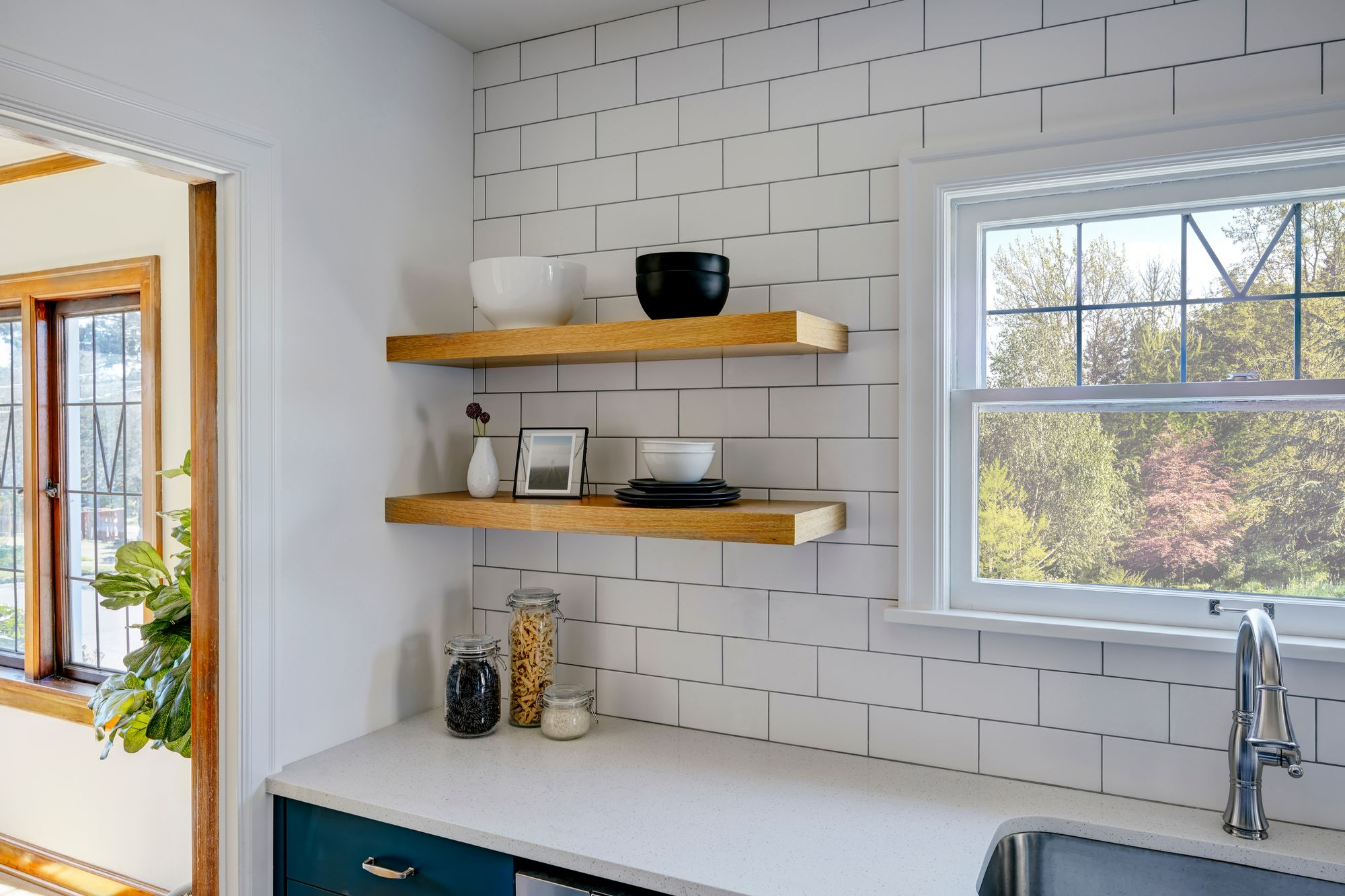 A kitchen with floating shelves.