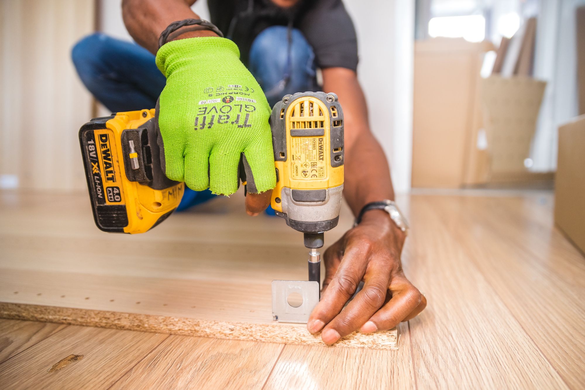 A handyman doing drilling on a piece of wood.
