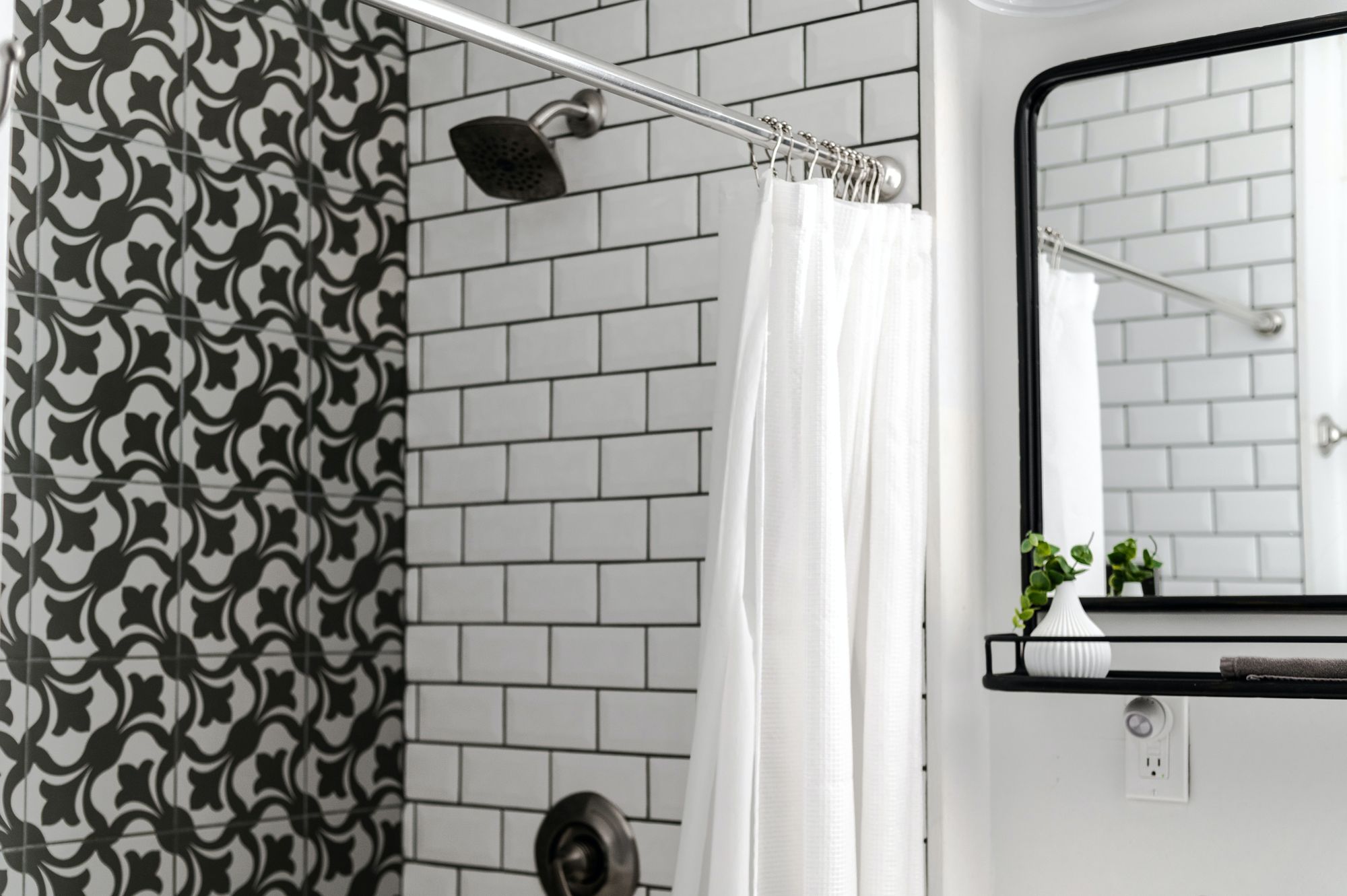 A shower curtain in a black-and-white bathroom.