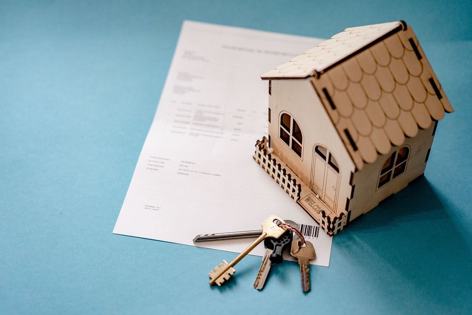 A small house, keys, and a document.