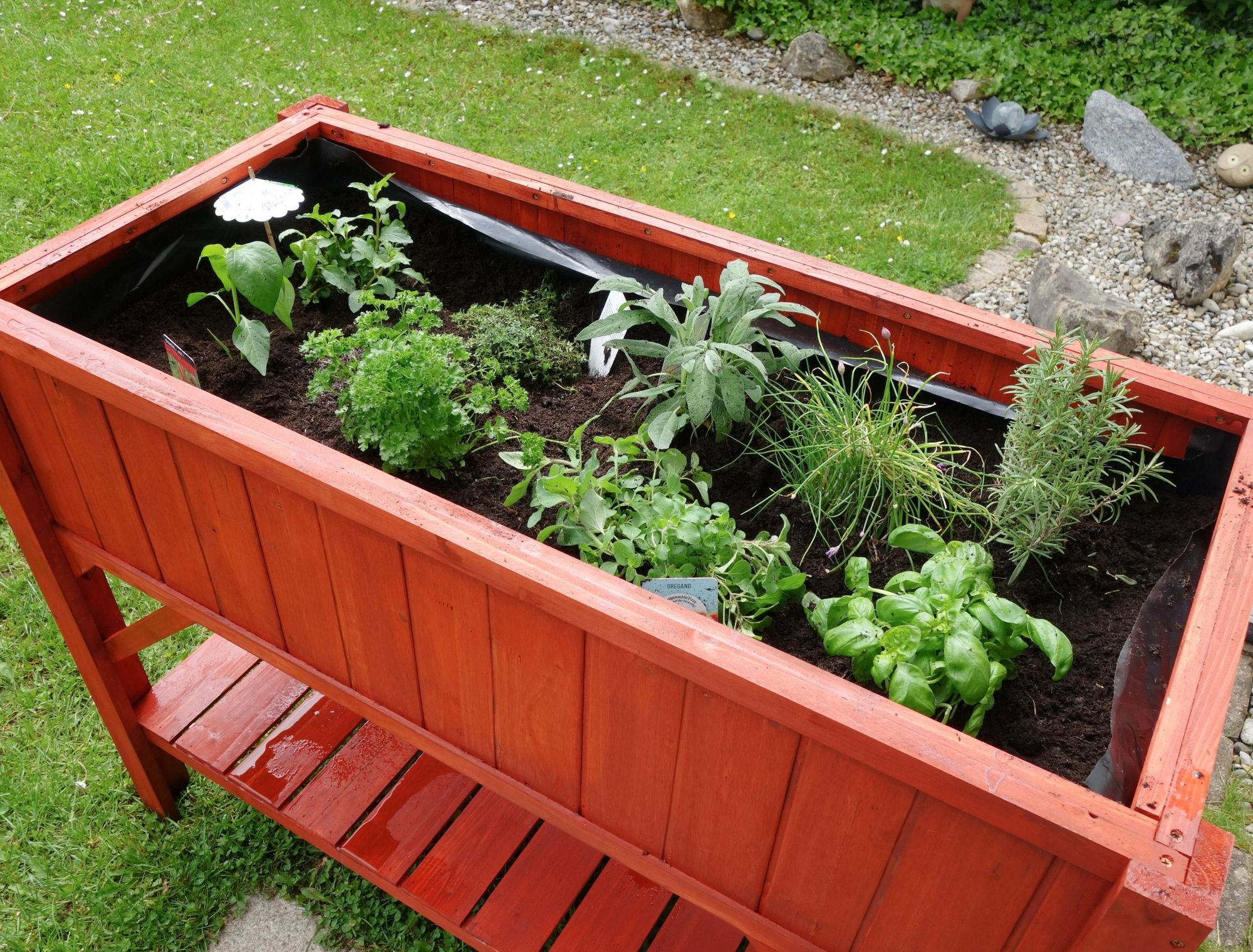 A red-colored raised garden bed.