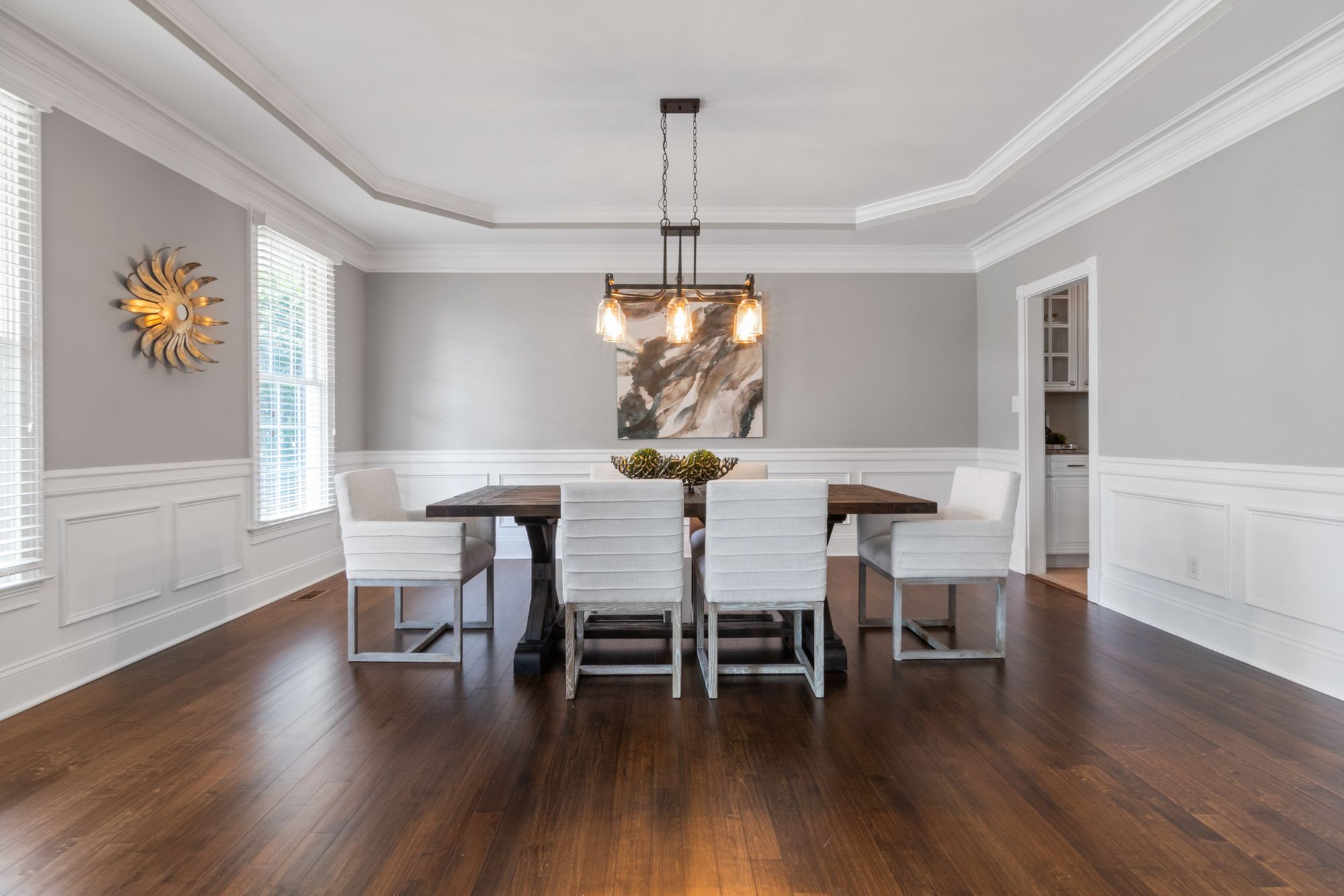 A dining room with wainscoted walls.