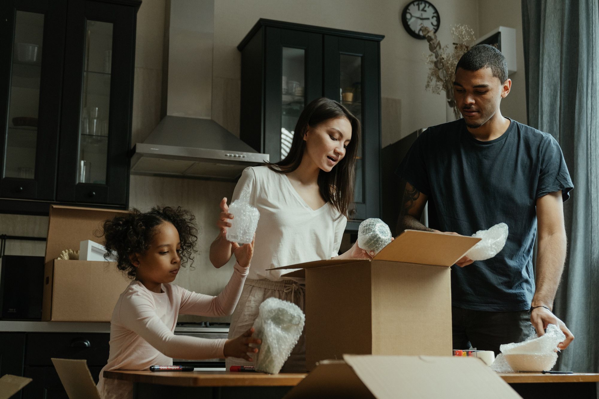 A young family unpacking their kitchen.